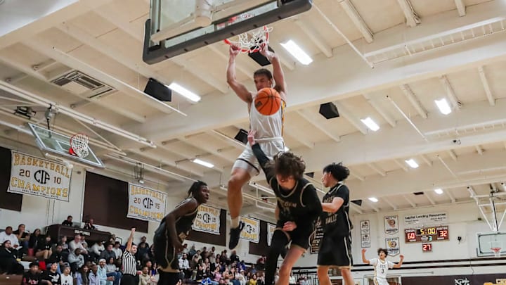 Crespi senior forward Peyton White throws down a dunk against Golden Valley at home.