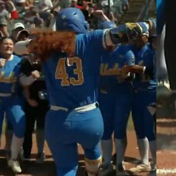 UCLA softball celebrates a home run that would later be reviewed in the WCWS.