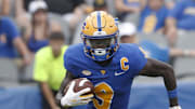 Aug 31, 2024; Pittsburgh, Pennsylvania, USA;  Pittsburgh Panthers wide receiver Konata Mumpfield (9) runs the ball after a catch against the Kent State Golden Flashes during the third quarter at Acrisure Stadium. Pittsburgh won 55-24. Mandatory Credit: Charles LeClaire-Imagn Images