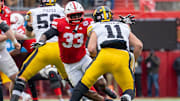 Iowa quarterback Mark Gronowski tries to elude Nebraska linebacker Marques Watson-Trent.