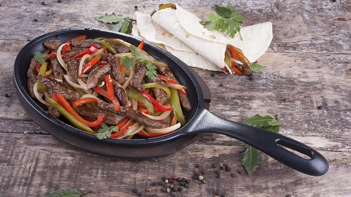 Victoria Fajita Skillet on wood tabletop.