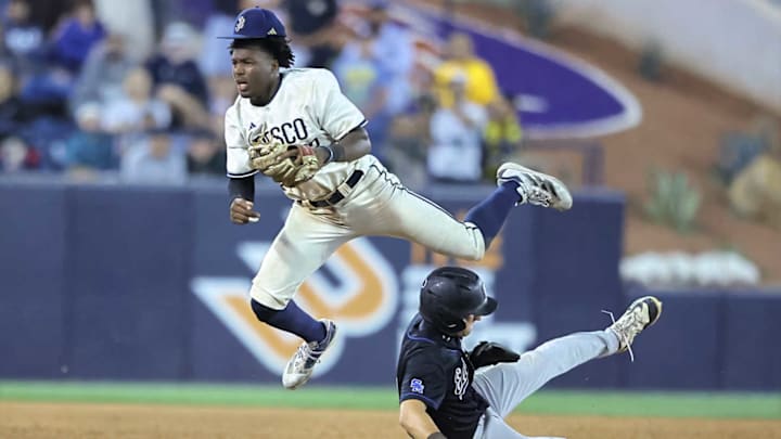 St. John Bosco second baseman James Clark goes high in the air to attempt a double play. Bosco won the Southern California Division 1 title with a 4-0 win over Patrick Henry, one of only two title games that were not decided by one run. 