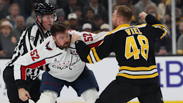 Dylan McIlrath of the Washington Capitals fights Jeffrey Viel of the Boston Bruins.