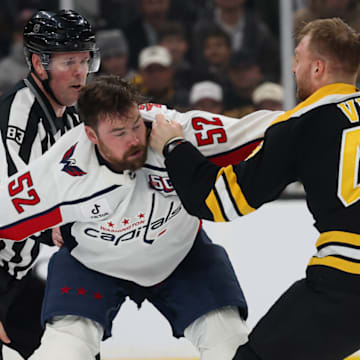 Dylan McIlrath of the Washington Capitals fights Jeffrey Viel of the Boston Bruins.