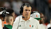 Nov 15, 2025; Miami Gardens, Florida, USA; Miami Hurricanes head coach Mario Cristobal watches from the sideline against NC State Wolfpack during the fourth quarter at Hard Rock Stadium. Mandatory Credit: Sam Navarro-Imagn Images