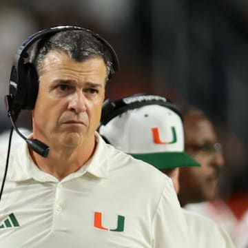 Nov 15, 2025; Miami Gardens, Florida, USA; Miami Hurricanes head coach Mario Cristobal watches from the sideline against NC State Wolfpack during the fourth quarter at Hard Rock Stadium. Mandatory Credit: Sam Navarro-Imagn Images