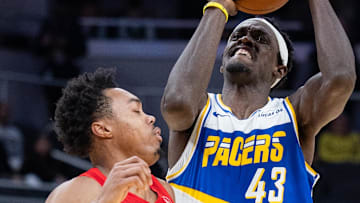 Indiana Pacers forward Pascal Siakam shoots the ball while Toronto Raptors forward Scottie Barnes defends.
