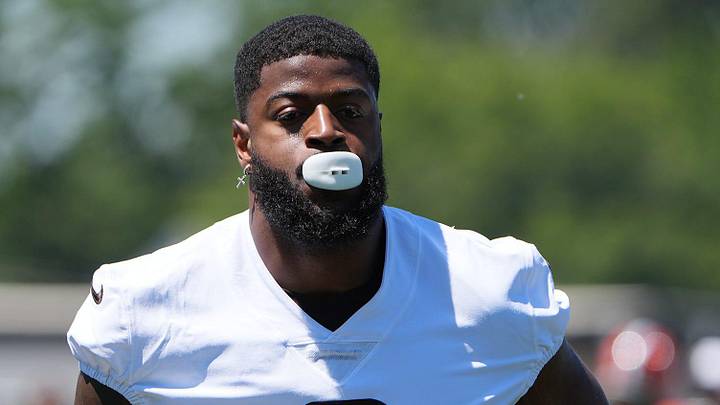 Cleveland Browns Jared Verse jog onto the field for team OTAs