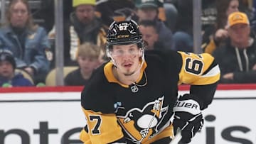 Mar 2, 2025; Pittsburgh, Pennsylvania, USA;  Pittsburgh Penguins right wing Rickard Rakell (67) skates with the puck against the Toronto Maple Leafs during the first period at PPG Paints Arena. Mandatory Credit: Charles LeClaire-Imagn Images