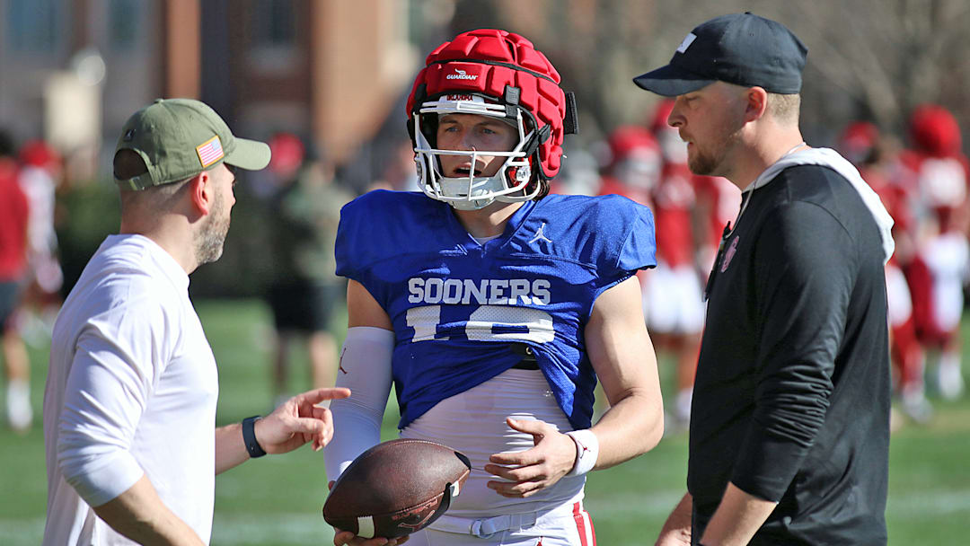 Oklahoma coaches John Kuceyeski (left) and Ben Arbuckle with Sooners quarterback John Mateer.