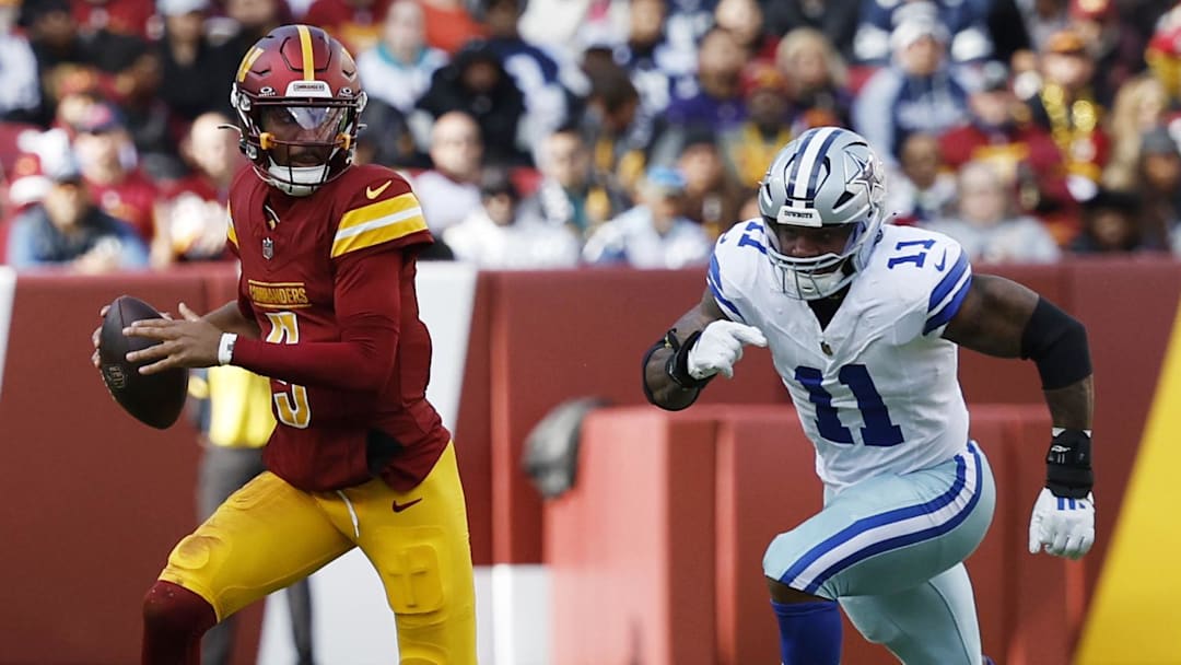Nov 24, 2024; Landover, Maryland, USA; Washington Commanders quarterback Jayden Daniels (5) scrambles from Dallas Cowboys linebacker Micah Parsons (11) at Northwest Stadium. Mandatory Credit: Geoff Burke-Imagn Images
