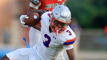 Bolles' Naeem Burroughs (3) is tackled by Mandarin's Devon Ray (14) during the second quarter of a high school football matchup Thursday, May 23, 2024 at Mandarin High School in Jacksonville, Fla. Mandarin defeated Bolles 35-14.