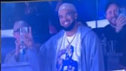 Knicks forward Karl-Anthony Towns gestures to fans at Yankees vs. Mets Subway Series game at Yankee Stadium.