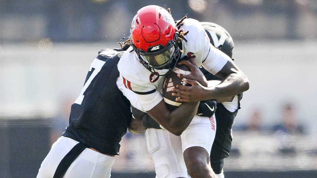 Sep 19, 2026; Nashville, Tennessee, USA; NC State Wolfpack quarterback CJ Bailey (11) gets tackled by Vanderbilt Commodores safety Ricardo Jones (7) and safety Jailen Ruth (14) during the second half at FirstBank Stadium. Mandatory Credit: Steve Roberts-Imagn Images Sep 19, 2026; Nashville, Tennessee, USA; NC State Wolfpack quarterback CJ Bailey (11) gets tackled by Vanderbilt Commodores safety Ricardo Jones (7) and safety Jailen Ruth (14) during the second half at FirstBank Stadium. Mandatory Credit: Steve Roberts-Imagn Images