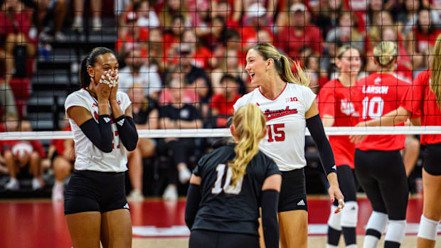 Andi Jackson (15) smiles at Harper Murray (27) after Murray's block on a Jordan Larson kill attempt. 