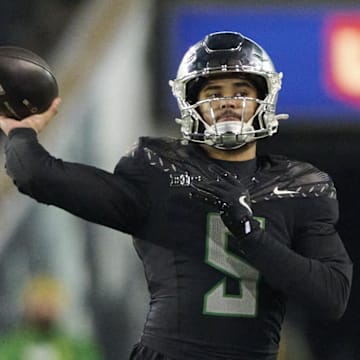 Nov 30, 2024; Eugene, Oregon, USA; Oregon Ducks quarterback Dante Moore (5) throws a pass during the second half against the Washington Huskies at Autzen Stadium. Mandatory Credit: Troy Wayrynen-Imagn Images