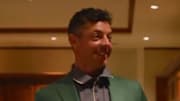 Rory McIlroy walks in the Masters champions locker room.