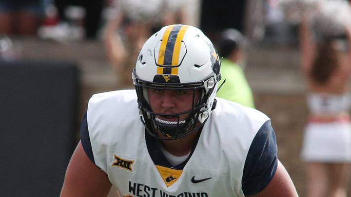 Oct 22, 2022; Lubbock, Texas, USA;  West Virginia Mountaineers offensive tackle Wyatt Milum (65) prepares to block against the Texas Tech Red Raiders in the second half at Jones AT&T Stadium and Cody Campbell Field. Mandatory Credit: Michael C. Johnson-Imagn Images