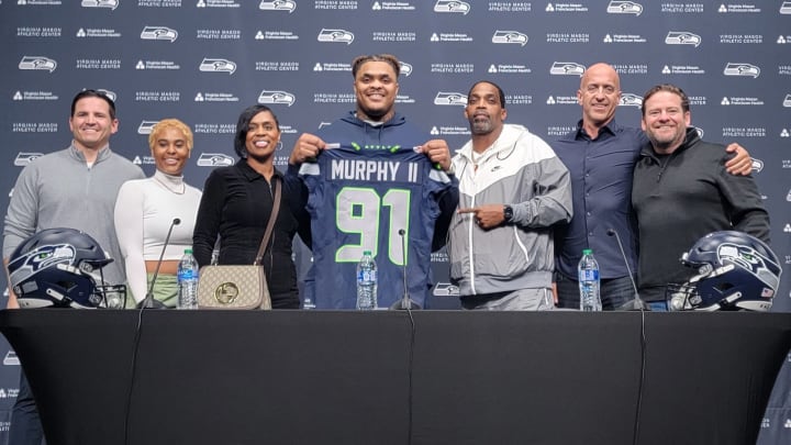 Seahawks first-round pick Byron Murphy II poses with his parents, girlfriend, agent, general manager John Schneider, and coach Mike Macdonald at the VMAC on Thursday.