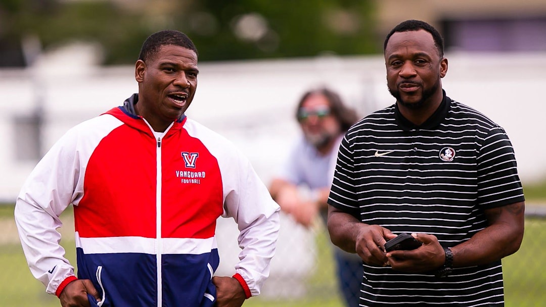 Vanguard Head Football Coach Edwin Farmer, left, talks with Florida State Defensive Back Coach Patrick Surtain, right, Wednesday. The Vanguard Knights held a Spring football practice at Booster Stadium Wednesday afternoon, May 24, 2023 in Ocala, FL. The Knights played Manatee High School in their Spring football matchup. [Doug Engle/Ocala Star Banner]2023