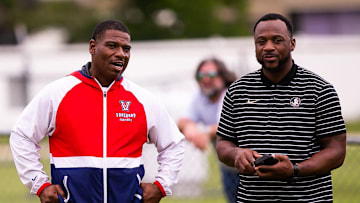 Vanguard Head Football Coach Edwin Farmer, left, talks with Florida State Defensive Back Coach Patrick Surtain, right, Wednesday. The Vanguard Knights held a Spring football practice at Booster Stadium Wednesday afternoon, May 24, 2023 in Ocala, FL. The Knights played Manatee High School in their Spring football matchup. [Doug Engle/Ocala Star Banner]2023