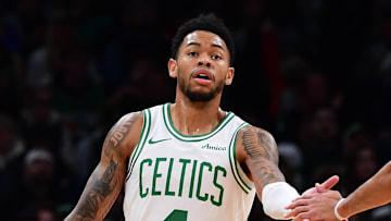 Nov 23, 2025; Boston, Massachusetts, USA; Boston Celtics guard Anfernee Simons (4) is congratulated by guard Derrick White (9) after a basket during the first half at TD Garden. Mandatory Credit: Bob DeChiara-Imagn Images