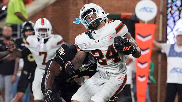 Sep 18, 2026; Winston-Salem, North Carolina, USA;  Miami (FL) Hurricanes defensive back Ethan O'Connor (24) intercepts a pass near the end zone tackled by Wake Forest Demon Deacons running back Kd Daniels (1)during the second half at Allegacy Federal Credit Union Stadium.  Mandatory Credit: Jim Dedmon-Imagn Images