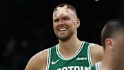 Boston Celtics center Kristaps Porzingis smiles upon returning to the court to shoot fouls shots.
