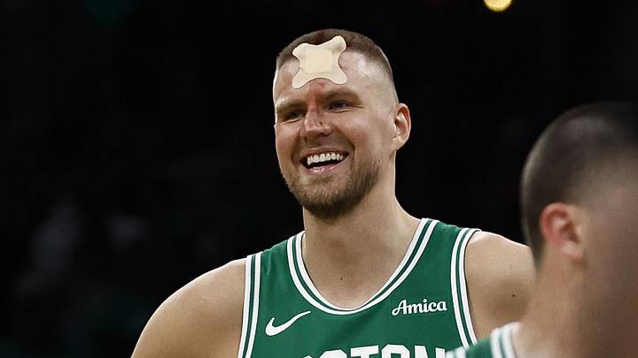 Apr 23, 2025; Boston, Massachusetts, USA; Boston Celtics center Kristaps Porzingis (8) smiles upon returning to the court to shoot fouls shots after being cut by an elbow during the second half of game two of the first round of the 2024 NBA Playoffs against the Orlando Magic at TD Garden. Mandatory Credit: Winslow Townson-Imagn Images