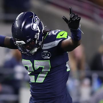 Oct 20, 2025; Seattle, Washington, USA; Seattle Seahawks cornerback Riq Woolen (27) celebrates after breaking up a pass during the fourth quarter against the Houston Texans at Lumen Field. Mandatory Credit: Kevin Ng-Imagn Images