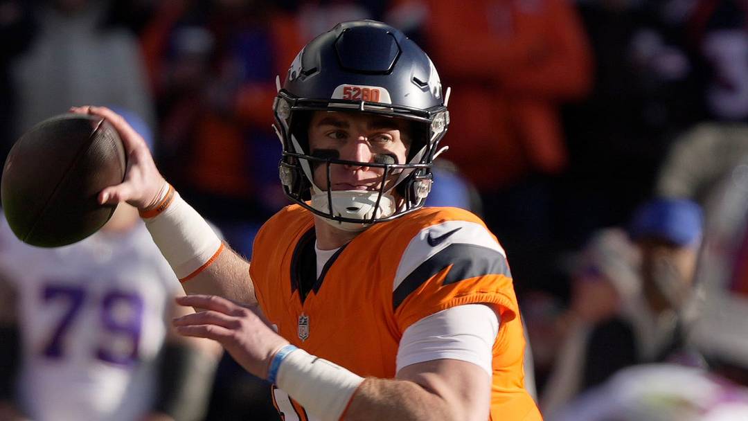 Denver Broncos quarterback Bo Nix gets ready to fire a pass to a receiver while the Bills defense keep an eye on him during first half action at Empower FIeld at Mile High in Denver, Colorado on Jan. 17, 2026.