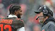 Cleveland Browns quarterback Shedeur Sanders (12) talks with coach Kevin Stefanski during a game against the Tennessee Titans on Dec. 7, 2025, in Cleveland.