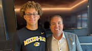 Westside quarterback Braylen Warren stands with Missouri Tigers head coach Eli Drinwkitz. 