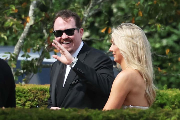 Comedian Shane Gillis waves to the spectators at the Olivia Culpo and Christian McCaffrey. 
