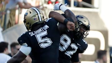 Purdue Boilermakers linebacker Nic Scourton (5) and Purdue Boilermakers defensive lineman Mo Omonode