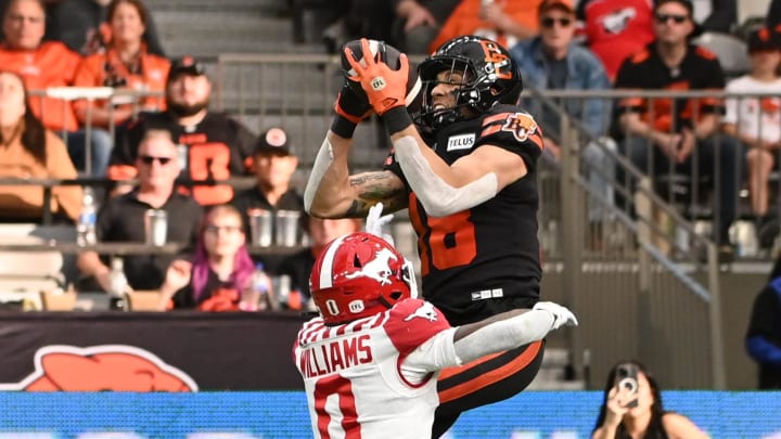 Jun 15, 2024; Vancouver, British Columbia, CAN; BC Lions wide receiver Justin McInnis (18) makes a catch against Calgary Stampeders defensive back Kobe Williams (0) during the second half at BC Place. Mandatory Credit: Simon Fearn-USA TODAY Sports