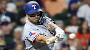 Texas Rangers second baseman Cody Freeman (39) hits a RBI single against the Houston Astros in the second inning at Daikin Park.