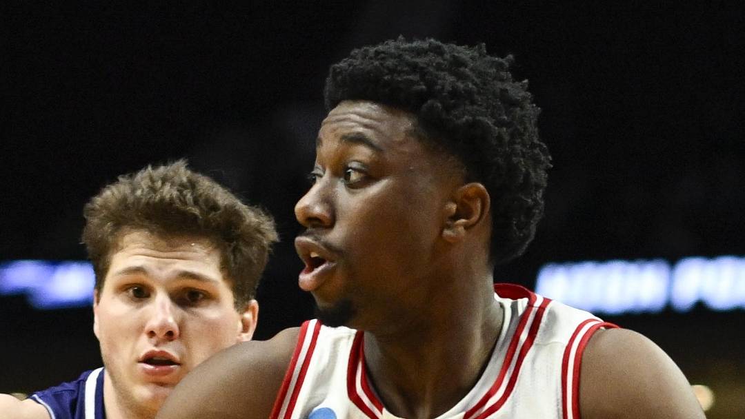 Mar 19, 2026; Portland, OR, USA; Wisconsin Badgers guard John Blackwell (25) drives to the basket against High Point Panthers guard Chase Johnston (99) during the second half of a first round game of the men's 2026 NCAA Tournament at Moda Center. Mandatory Credit: Troy Wayrynen-Imagn Images