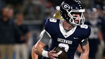 Greenwood's Kane Archer is chased out of the pocket by a Pulaski Academy defender while looking for a receiver during the 5A West Conference game on Oct. 28 at Smith Robinson Stadium.