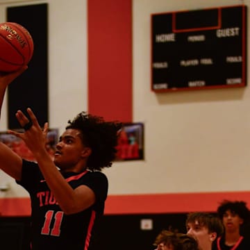 St. Cloud Tech boys basketball senior Yusupha Badji shoots a floater during a game Dec. 28, 2024 against Hutchinson at Tech High School. The Tigers lost 50-47.