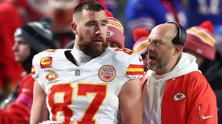Jan 21, 2024; Orchard Park, New York, USA; Kansas City Chiefs tight end Travis Kelce (87) talks with offensive coordinator Matt Nagy during the first half of the 2024 AFC divisional round game at Highmark Stadium.