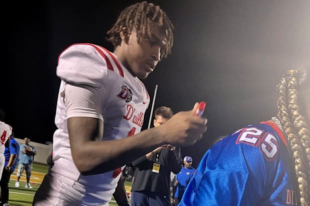 Dakorien Moore signs a jersey after Duncanville's win over DeSoto in nationally ranked rivalry.