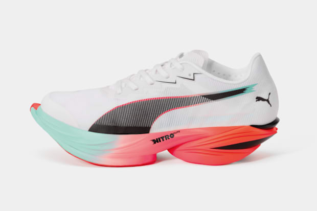 White, orange, and black PUMA running shoes.