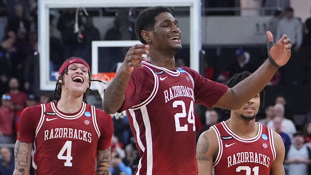 Mar 22, 2025; Providence, RI, USA; Arkansas Razorbacks forward Trevon Brazile (4), forward Billy Richmond III (24) and guard D.J. Wagner (21) celebrate after defeating the St. John's Red Storm in a second round men’s NCAA Tournament game at Amica Mutual Pavilion. Mandatory Credit: Gregory Fisher-Imagn Images