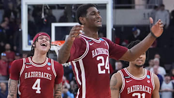 Mar 22, 2025; Providence, RI, USA; Arkansas Razorbacks forward Trevon Brazile (4), forward Billy Richmond III (24) and guard D.J. Wagner (21) celebrate after defeating the St. John's Red Storm in a second round men’s NCAA Tournament game at Amica Mutual Pavilion. Mandatory Credit: Gregory Fisher-Imagn Images