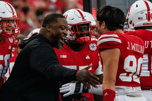 James Williams celebrates the Nebraska defense's final stop of the game with defensive line  coach Terrance Knighton.   