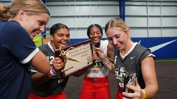 Marley Jackson shows off her Jennie Finch Empowerment Award with teammates.