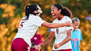 Arkansas soccer players celebrate a goal against Ole Miss.