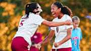 Arkansas soccer players celebrate a goal against Ole Miss.