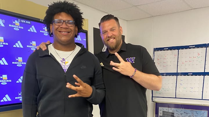 Texas recruit Pulelei'ite Primus and UW line coach Michael Switzer meet. Texas recruit Pulelei'ite Primus and UW line coach Michael Switzer meet.